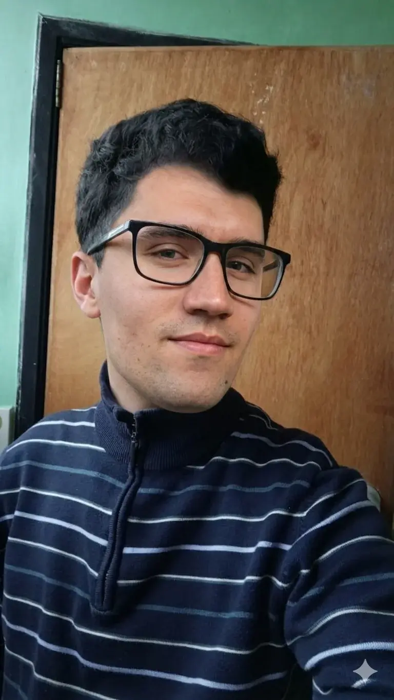 A man wearing glasses and a striped sweater.