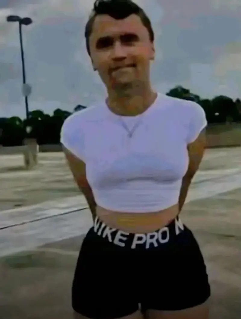 A woman in shorts and a white shirt.