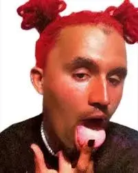 A man with red hair and a pink tongue.