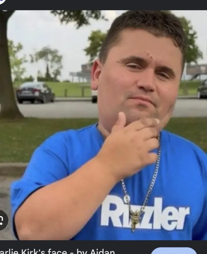 A man in a blue shirt is talking to someone.