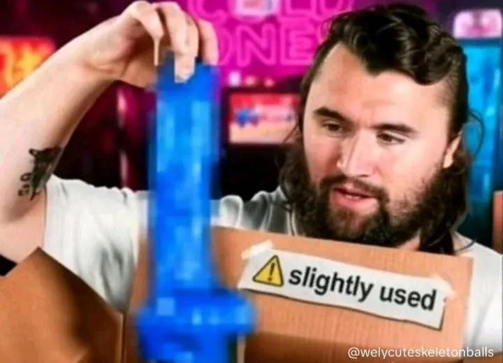 A man holding a box with a sign on it.