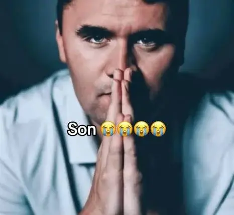 A man with his hands clasped to his face.