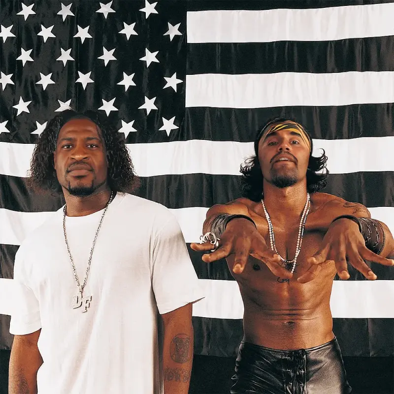 Two men standing in front of an american flag.