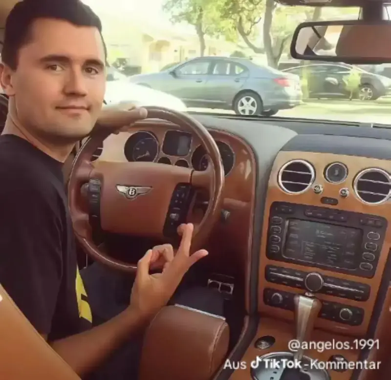 A man driving a car with a steering.