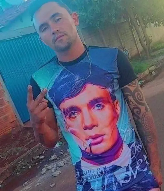 A man with tattoos and a t - shirt.