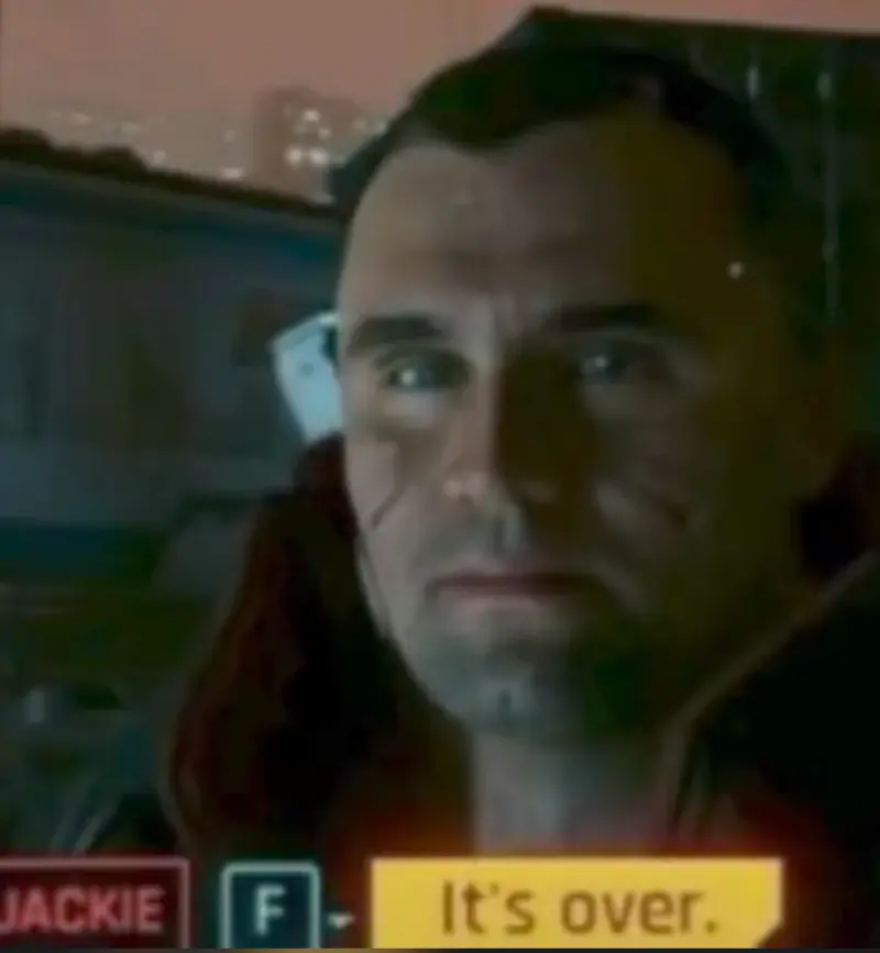A man in a red jacket is looking at the camera.