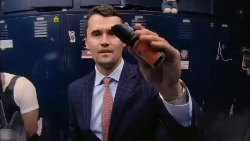 A man in a suit holding a cell.