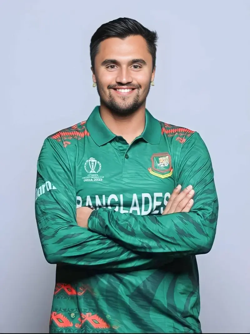 A man in a green shirt with his arms crossed.