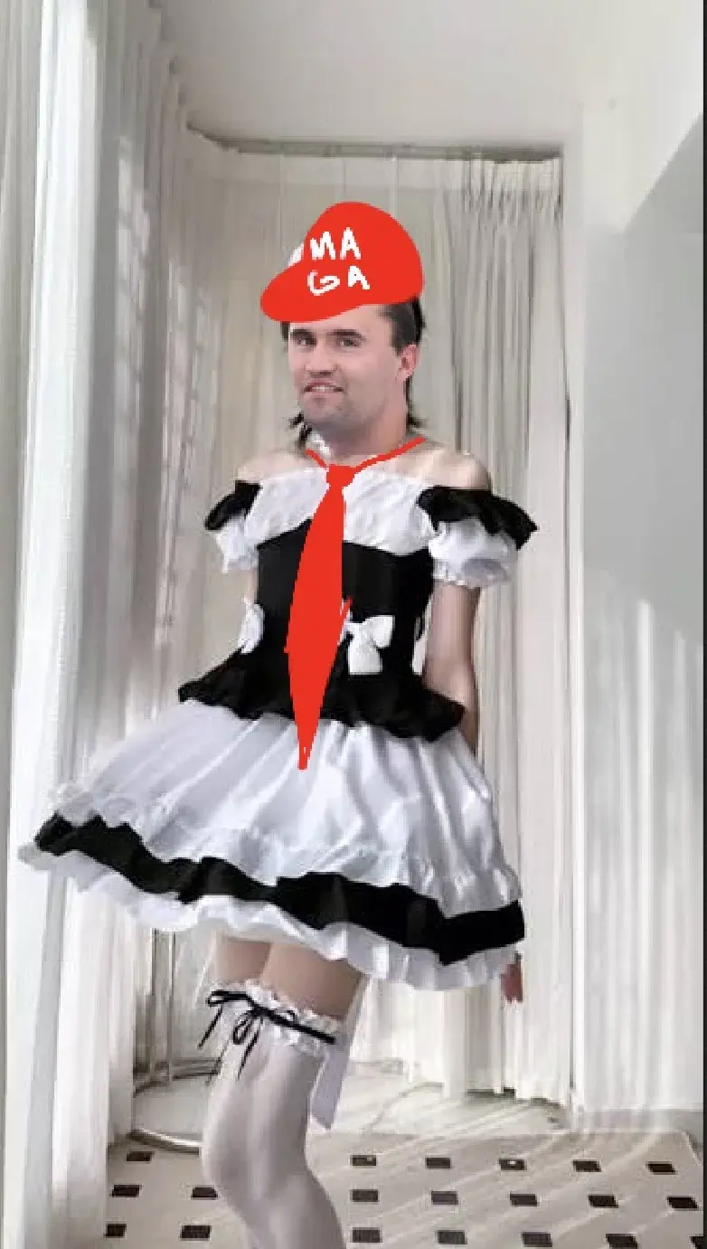 A man in a white dress and red hat.