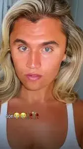 A woman with blonde hair and a white tank top.