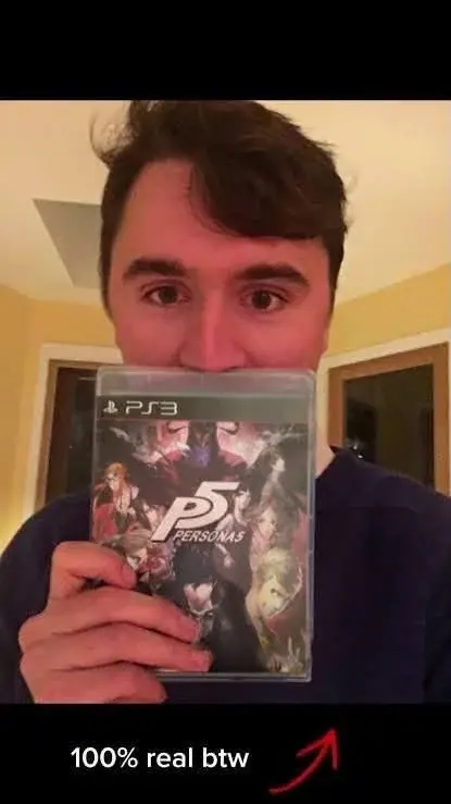 A man holding up a video game.