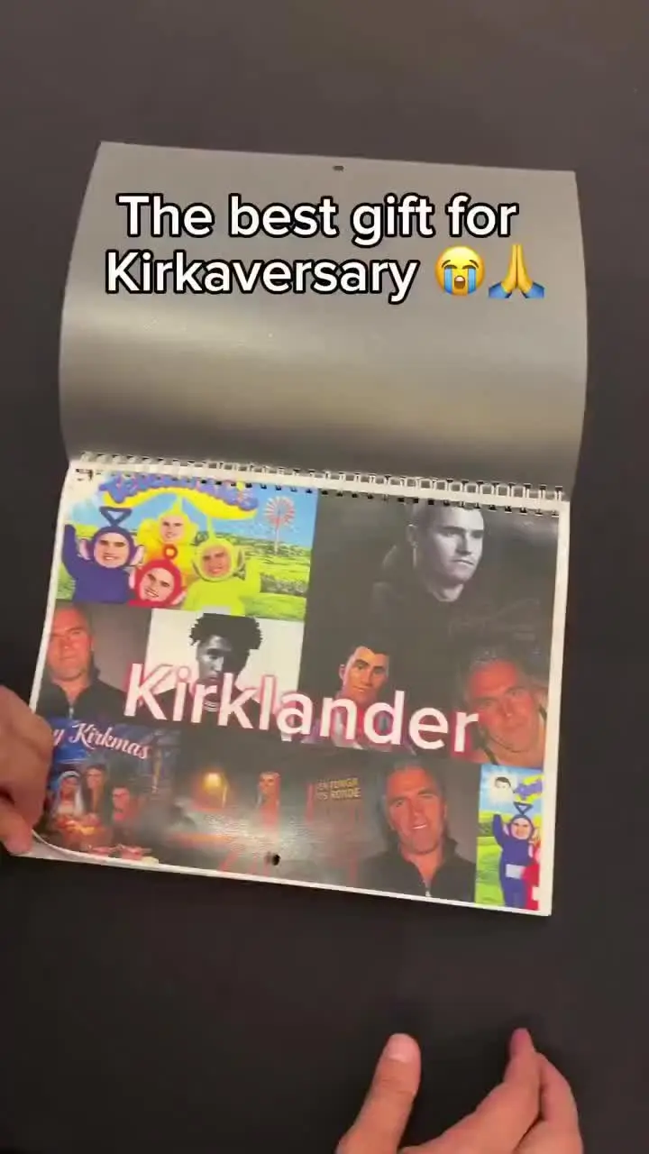 A person holding a calendar with a picture of a man.