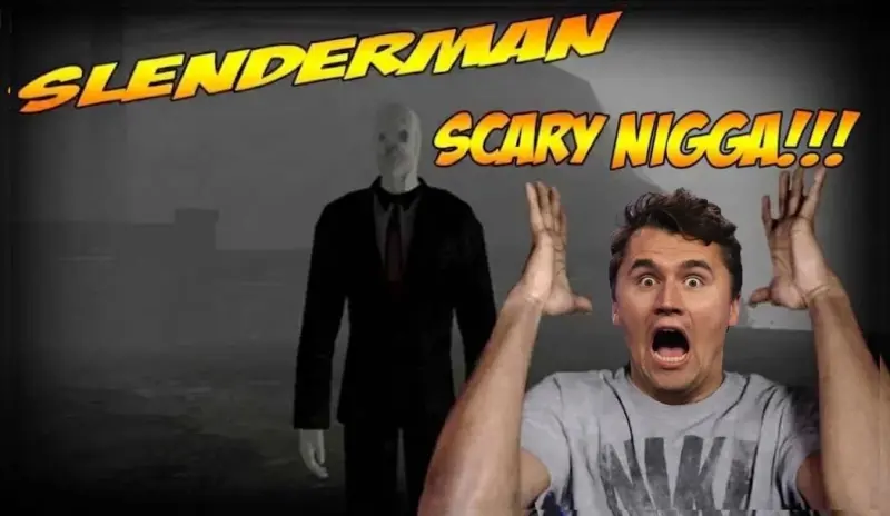A man in a grey shirt is holding his hands up.