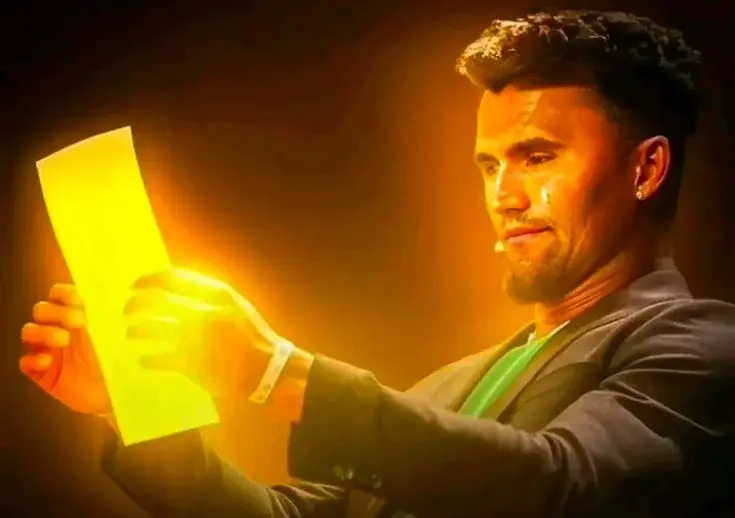 A man holding a yellow light in his hand.
