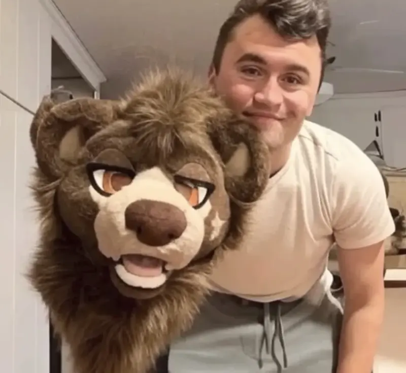 A man holding a stuffed animal in his arms.