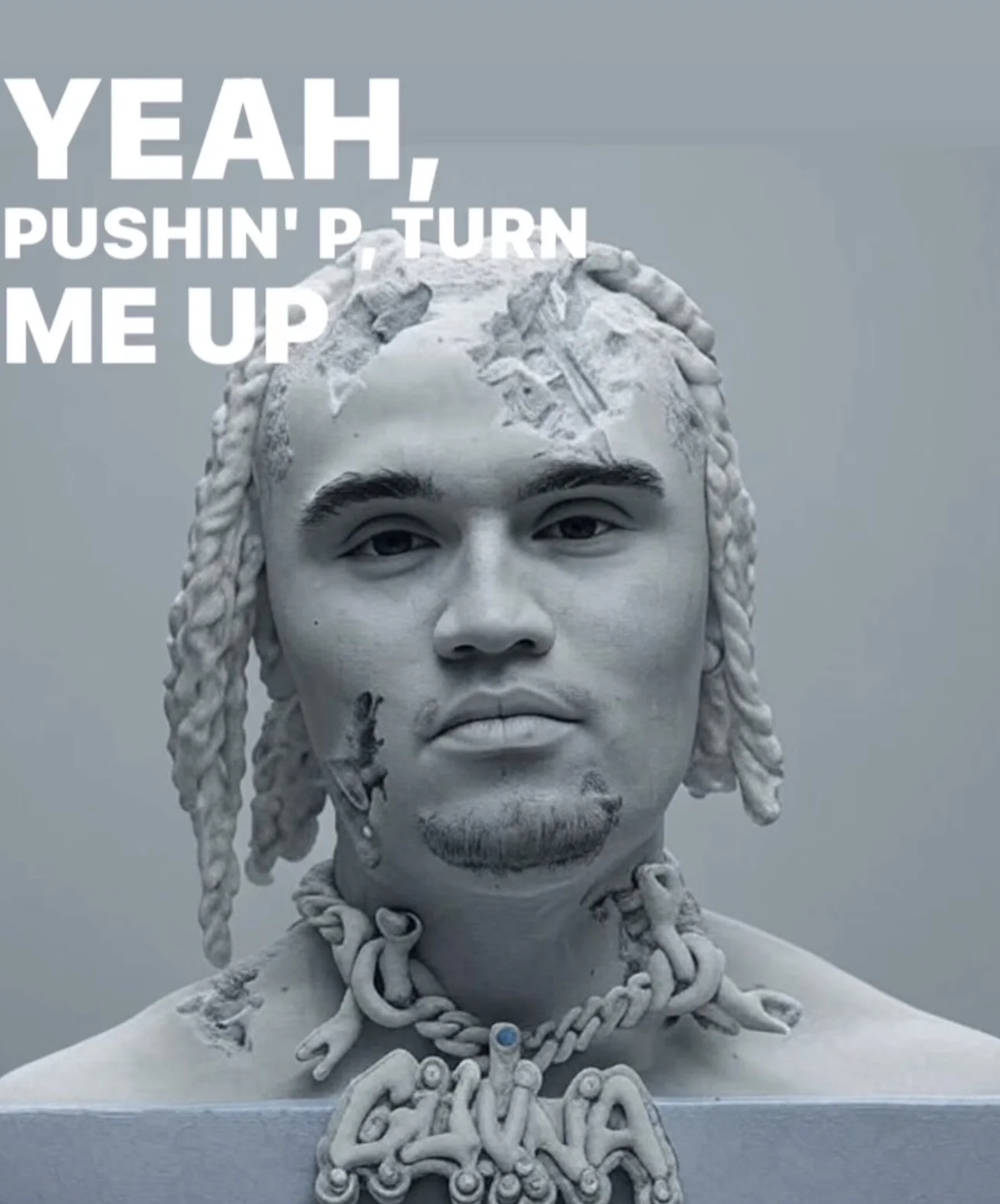 A white sculpture with the words yeah push up.