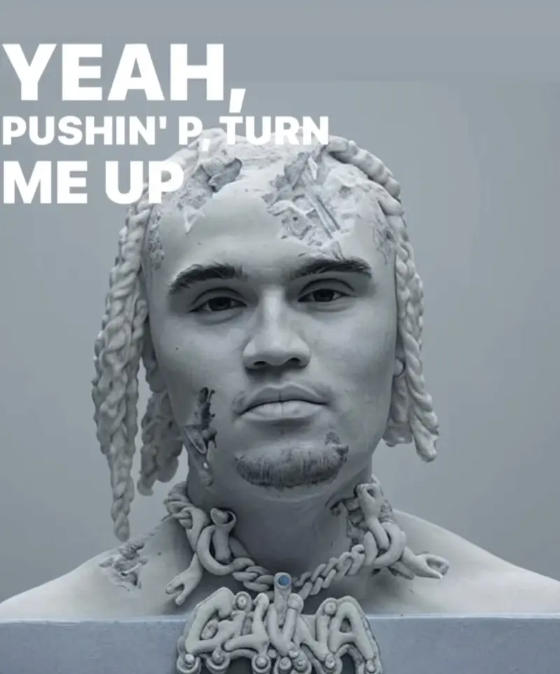 A white sculpture with the words yeah push up.