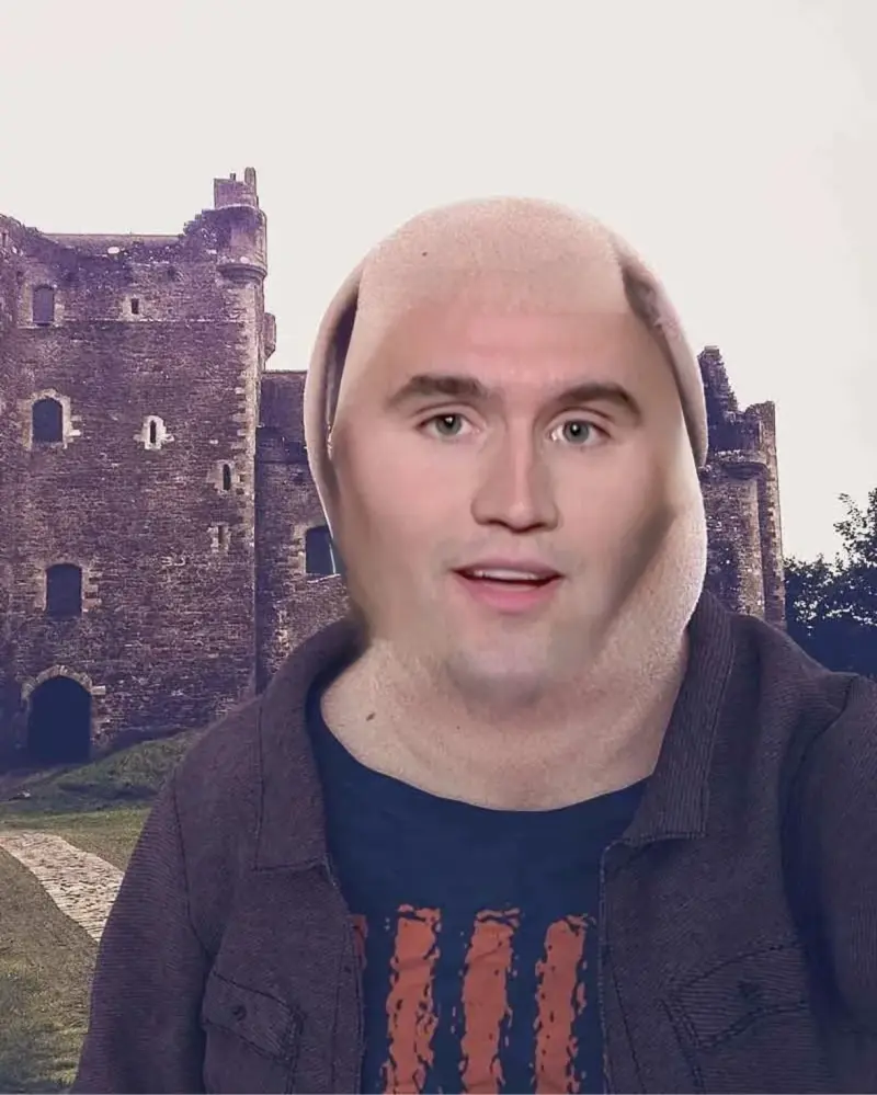 A man with a bald hair and a hoodie.