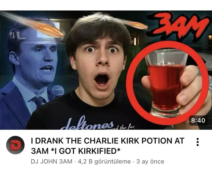 A man holding a glass of red liquid.