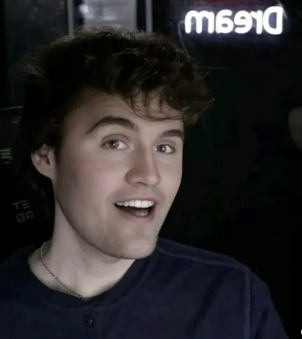 A man with a black shirt and a blue shirt.