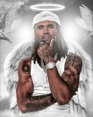 A man with tattoos and angel wings.