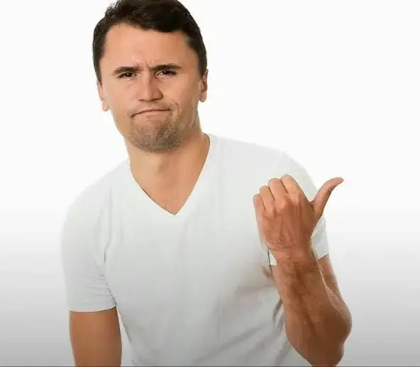 A man in a white shirt is making a gesture.