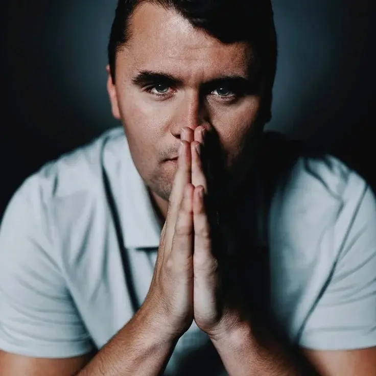 A man with his hands clasped to his face.