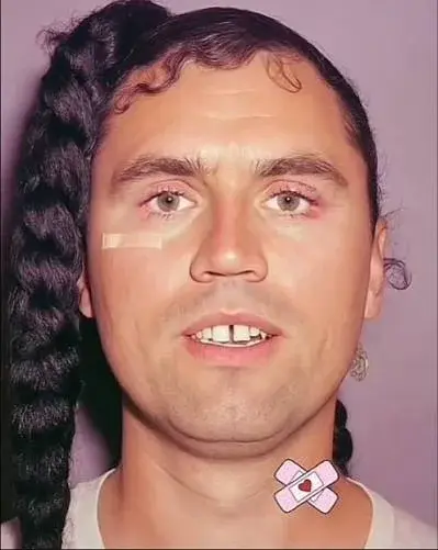 A man with a pink ribbon around his neck.