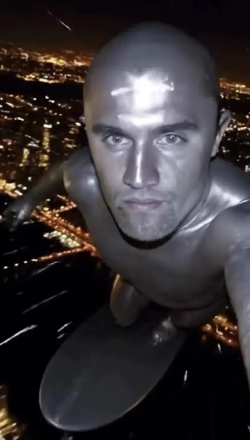 A man in a suit is suspended over the city.
