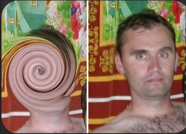 A man with a large hair curl on his head.